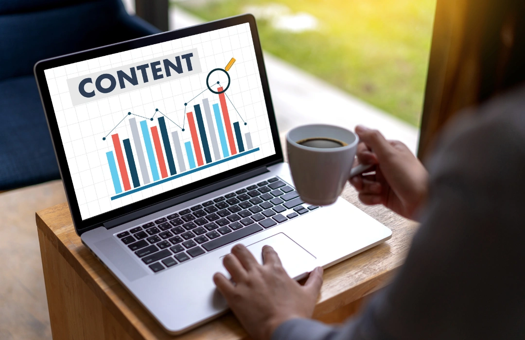 Professional analyzing content performance metrics on a laptop, showcasing a bar chart under the heading “CONTENT,” representing data-driven strategy by a top SEO firm